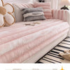 Pink anti-slip plush sofa cover with gray stripes and fluffy pillows