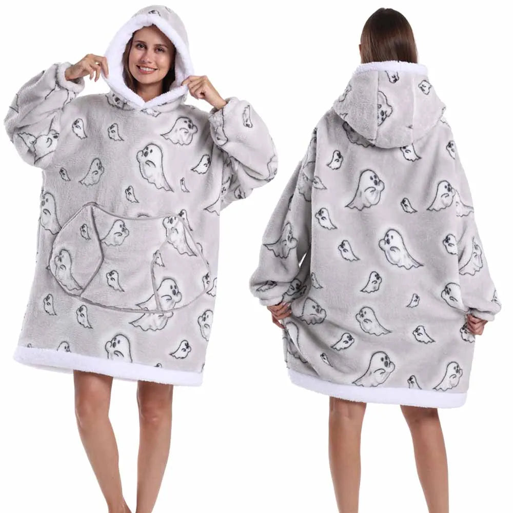 A woman models a gray patchwork fleece hoodie with a hood and a pattern of small bird graphics.