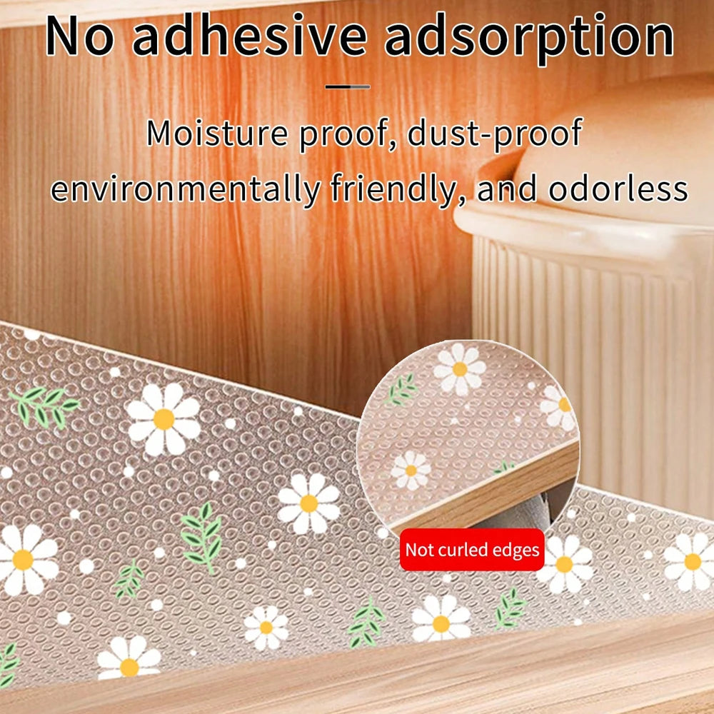 Reusable silicone drawer mat with a floral pattern protecting kitchen cabinets and drawers.