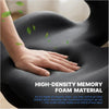 A hand rests on a dark gray memory foam cushion, demonstrating the texture and support of the material.