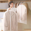 A white transparent zippered storage bag for clothes is hanging on a wooden rack.
