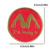 Red embroidered patch with a gold letter M and the text I'm loving it