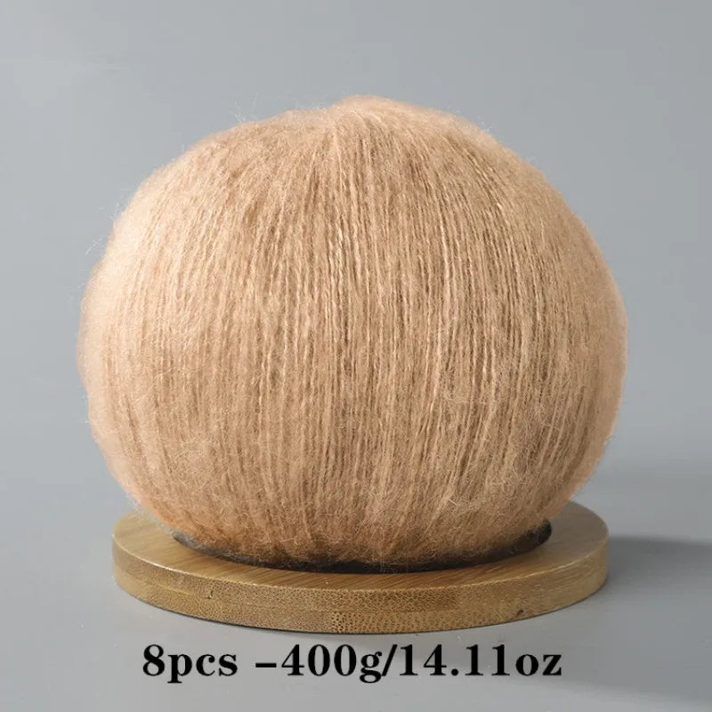 A ball of light beige mohair yarn used for crafting.