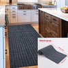 A black-gray striped runner rug displayed on a wooden floor next to kitchen cabinetry.