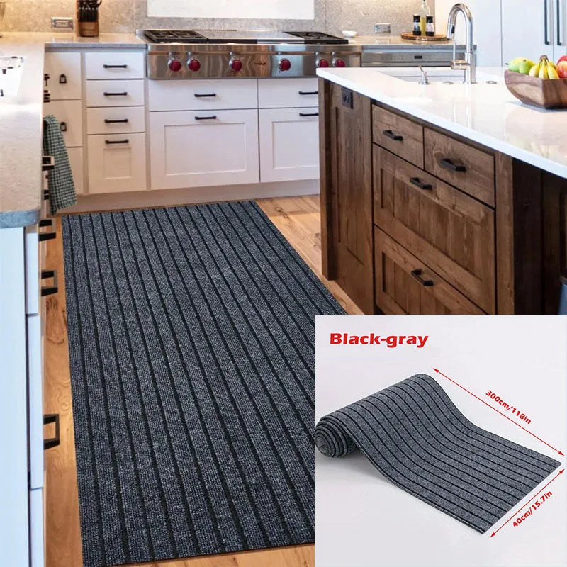 A black-gray striped runner rug displayed on a wooden floor next to kitchen cabinetry.