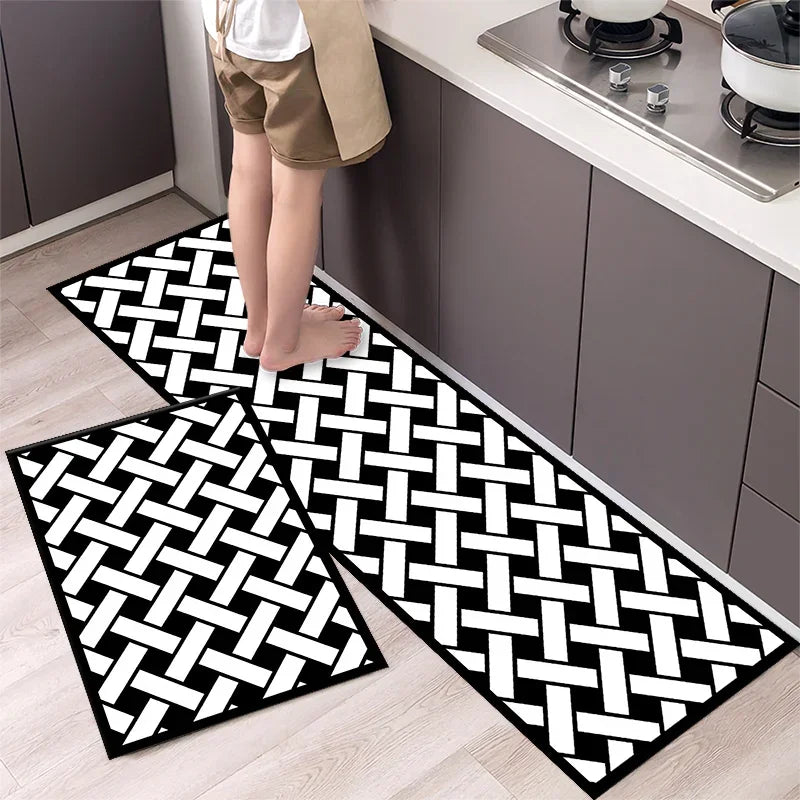 A black and white diamond print non-slip kitchen rug set displayed on a light wood floor.