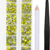 A clear plastic container holds various yellow and silver crystal rhinestones and an applicator tool for crafting.