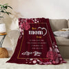 A deep red flannel throw blanket featuring a floral pattern and the text Best mom Ever Love you