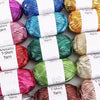 A collection of colorful metallic T-shirt yarn skeins in various shades including purple, blue, green, and gold.