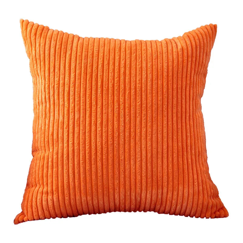 An orange ribbed corduroy cushion cover with vertical stripes.