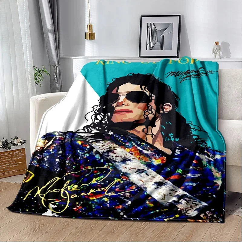 A retro printed flannel throw blanket featuring a portrait of a man with long dark hair and sunglasses against a vibrant teal