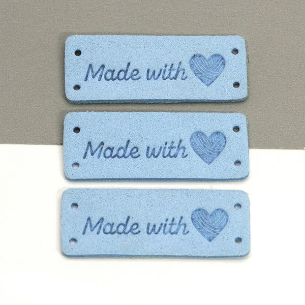 Three light blue felt tags with the text Made with and a heart design