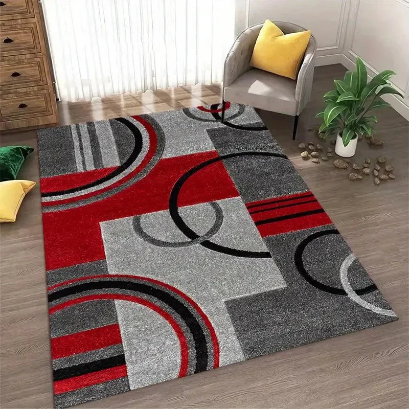 Abstract geometric area rug featuring a pattern of red, gray, and black circles and shapes.