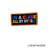 A rectangular black iron-on embroidered patch with the text IN A CLASS ALL BY MYSELF in colorful block letters.