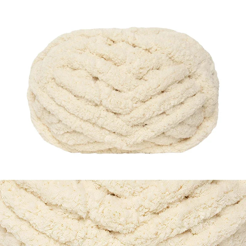 A ball of cream colored hand-knitted wool finger line scarf yarn.