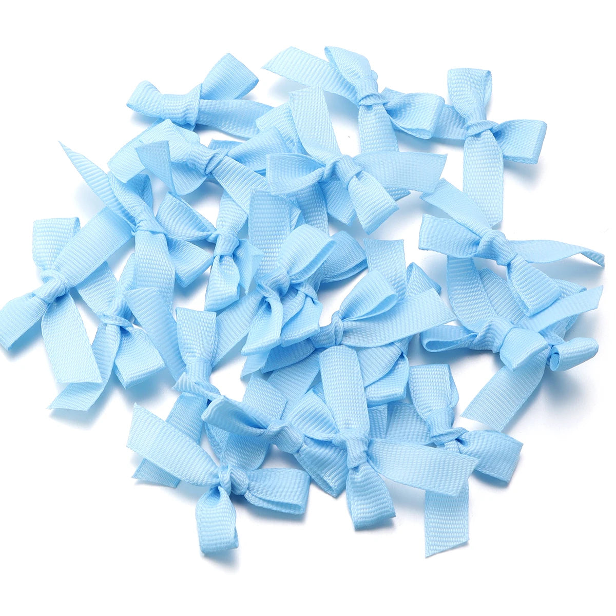 A pile of light blue satin ribbon bows for craft and decoration.