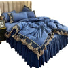 A navy blue bed skirt set featuring elegant lace edge trim and matching pillows on a bed.