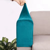 A teal velvet sofa armrest cover is being held by a hand, resting on a light-colored sofa.