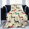 A tan flannel blanket featuring a repeating pattern of various colored dachshunds on a white background.