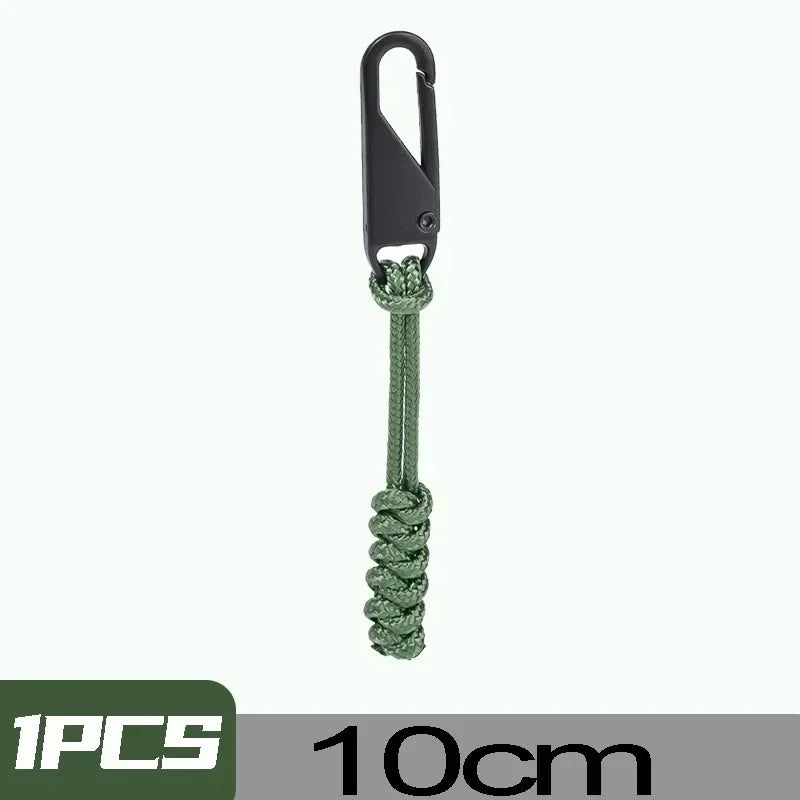 A black detachable zipper pull slider attached to a green cord.