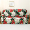 A floral patterned sofa cover featuring red leaves and white flowers on a light background.