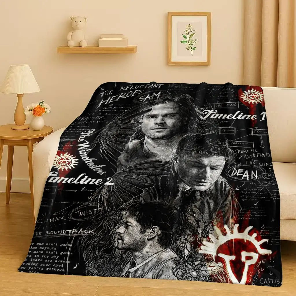 A black and white graphic blanket featuring silhouettes of movie heroes and timeline text