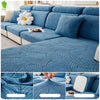 A teal leaf jacquard stretch sofa cover with anti-slip backing shown on a sectional sofa.