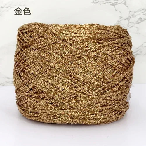 A ball of metallic gold silk crocheting and knitting yarn.