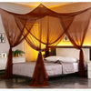 A square mosquito net bed canopy in brown fabric draped over a bed in a bedroom.