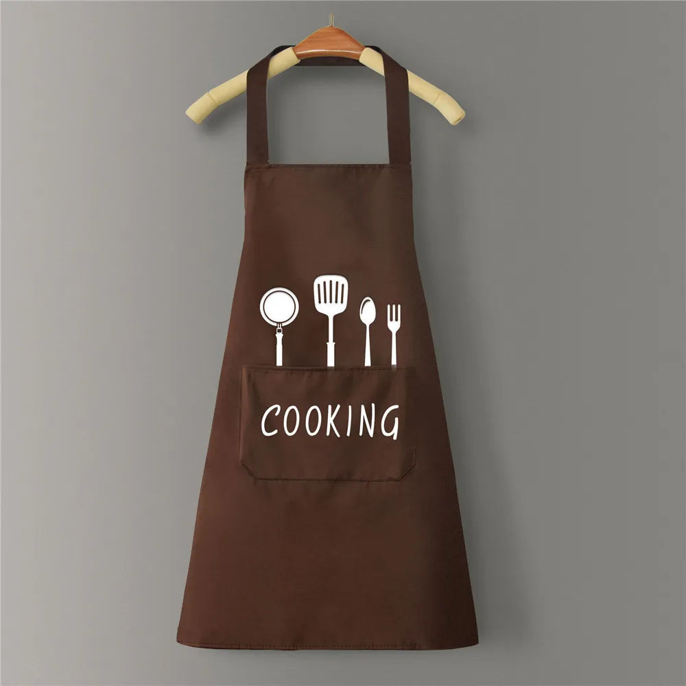 A brown waterproof oil-proof PVC kitchen apron with a pocket and the word COOKING printed on it, hanging on a wooden hanger.