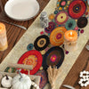 A bohemian polka dot table runner featuring colorful patterns, candles, and decorative elements on a wooden surface.