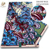 A bolt of brown and blue African wax print fabric with floral patterns.