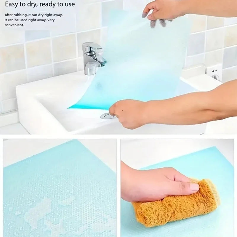 A hand is using a clear blue reusable EVA fridge shelf liner to dry it after rubbing.