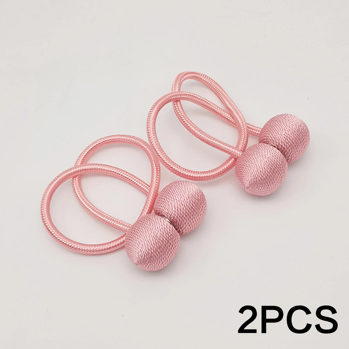 Two pink minimalist magnetic ball curtain tiebacks with pink elastic loops