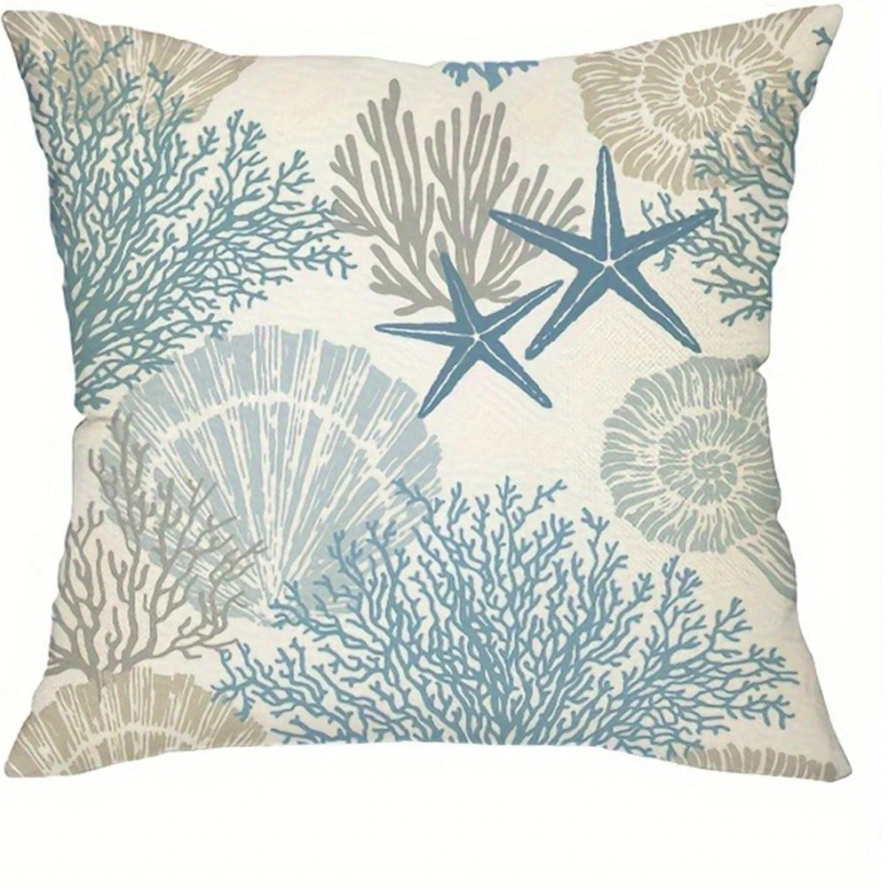 Decorative pillow cover featuring a pattern of blue-green coral and starfish on a light background.