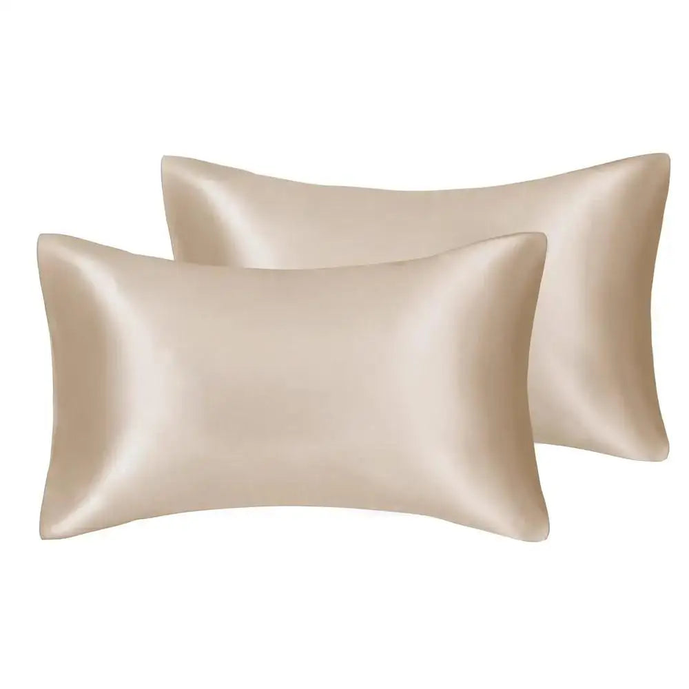 A close-up of a beige silky satin pillow cover.