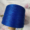 A skein of bright blue glitter metallic yarn is wound around a wooden bobbin for crochet or knitting.