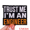 Black embroidered patch with white and orange text reading Trust me I'm an engineer