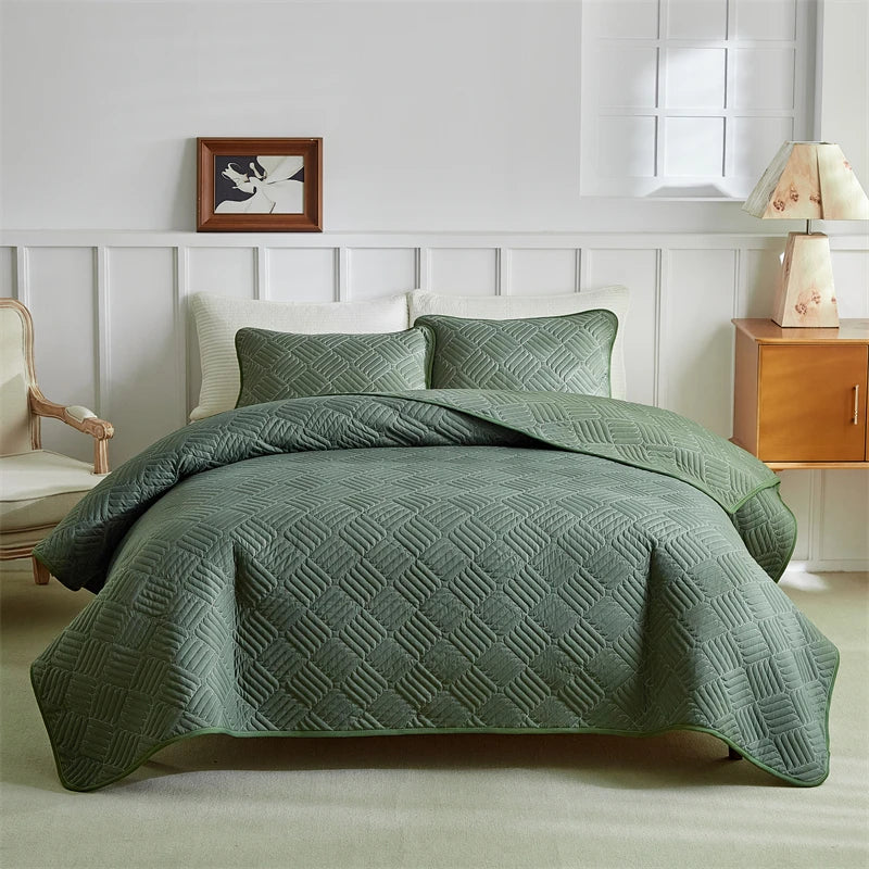 A light green quilted duvet and pillow set on a bed with white paneled walls.