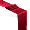 A vibrant red satin table runner draped elegantly for weddings and events.