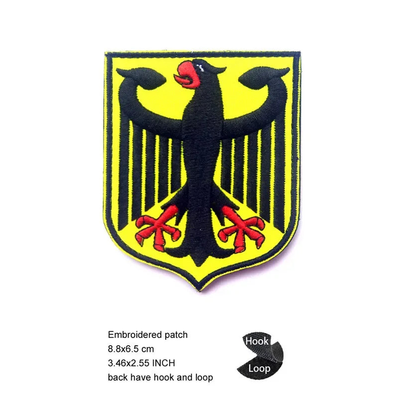 A black and yellow embroidered patch featuring an eagle shield design.