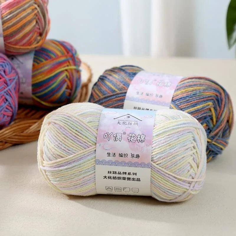 A ball of multi-colored yarn with a label for 4-Ply Cotton Knit Yarn for Gradient Projects