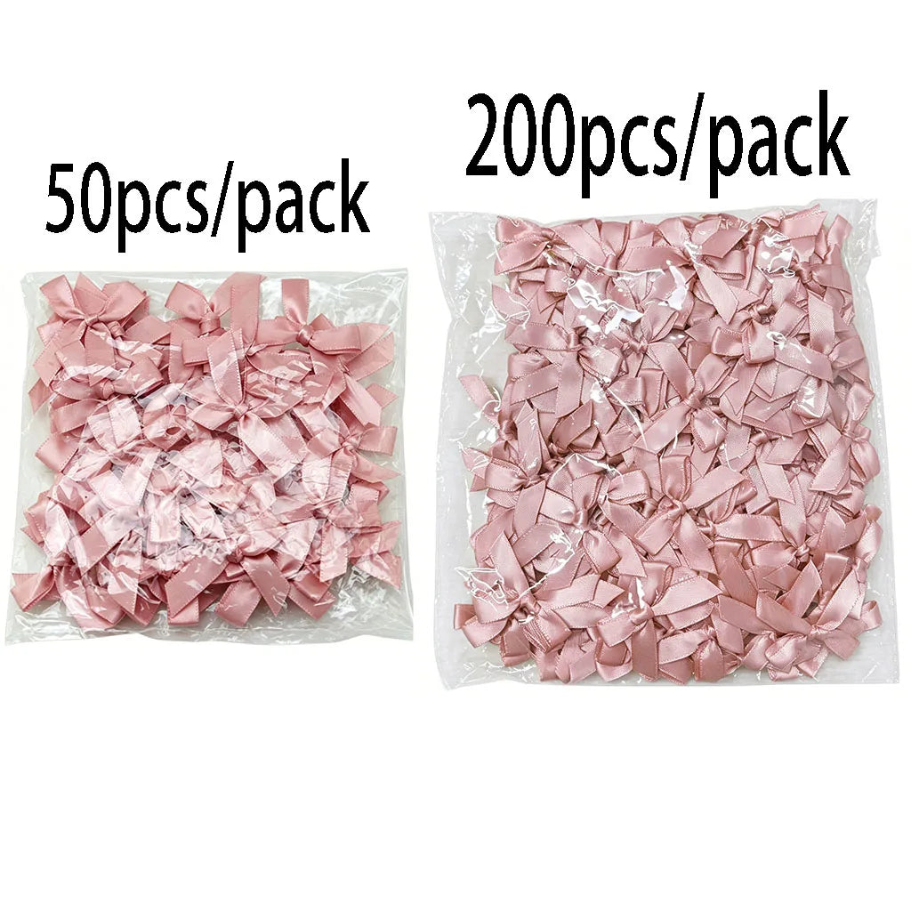Packaged pink satin ribbon bows for crafts and decor, available in 50 or 200 piece quantities.