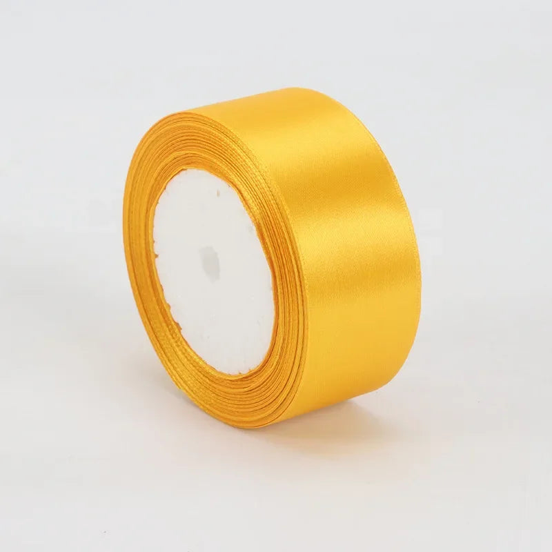 A roll of golden yellow satin ribbon measuring 4cm for crafts and gift wrapping.