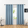Light blue blackout privacy curtains hanging in a window frame.