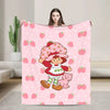 A pink strawberry shortcake plush throw blanket featuring a cute strawberry character design.