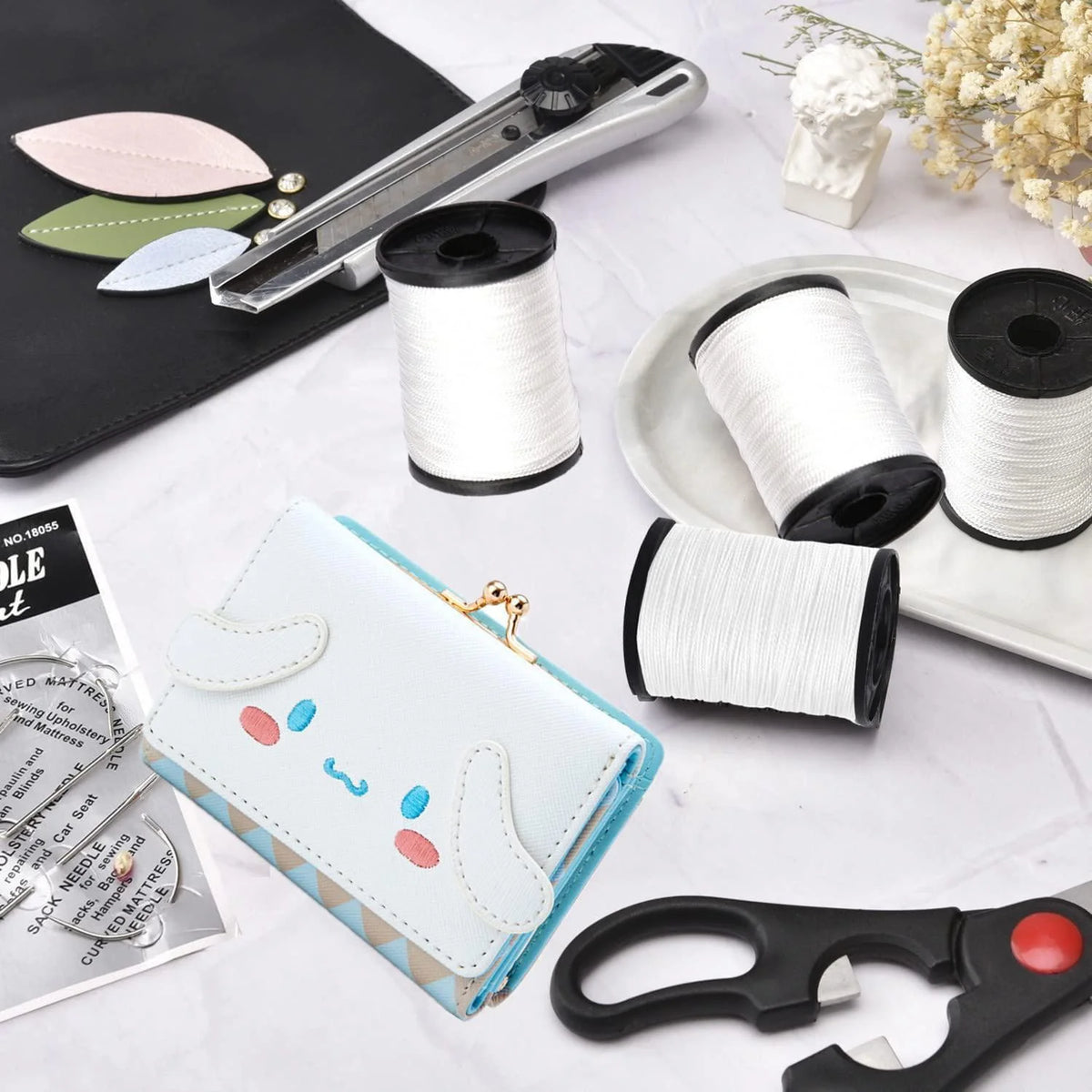 A kit for sewing heavy duty nylon upholstery thread including spools and a hand needle.
