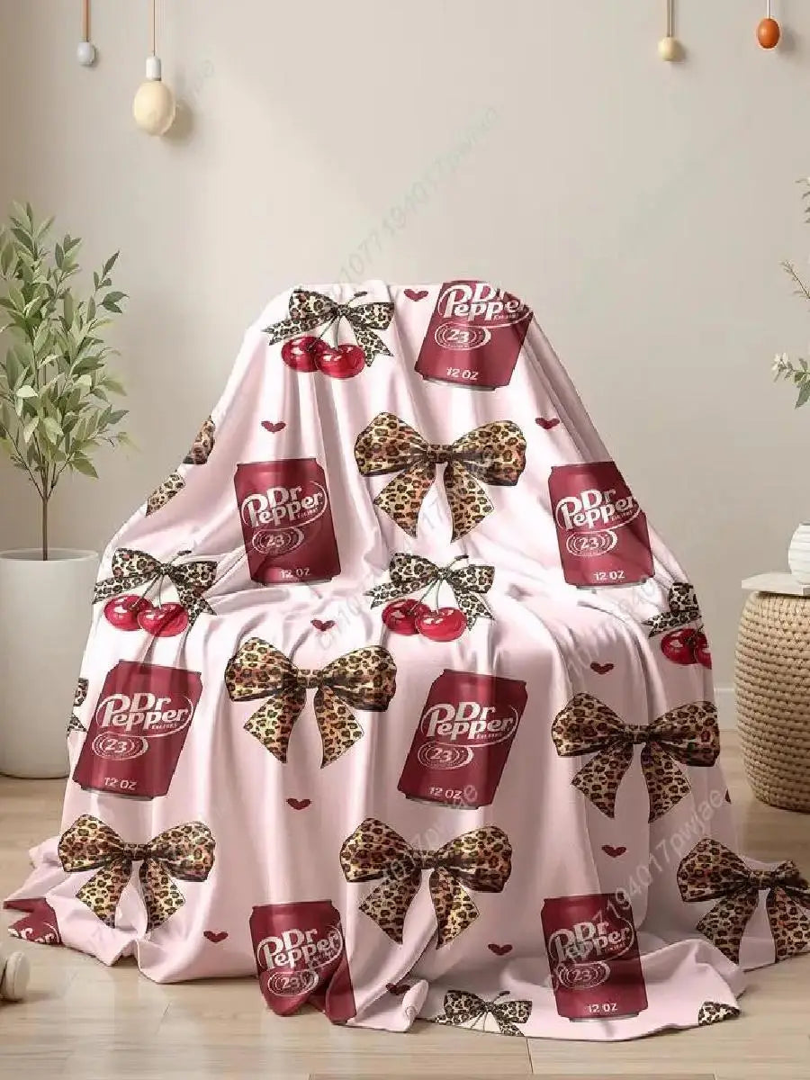Pink flannel throw blanket featuring a leopard print pattern and decorative bows.
