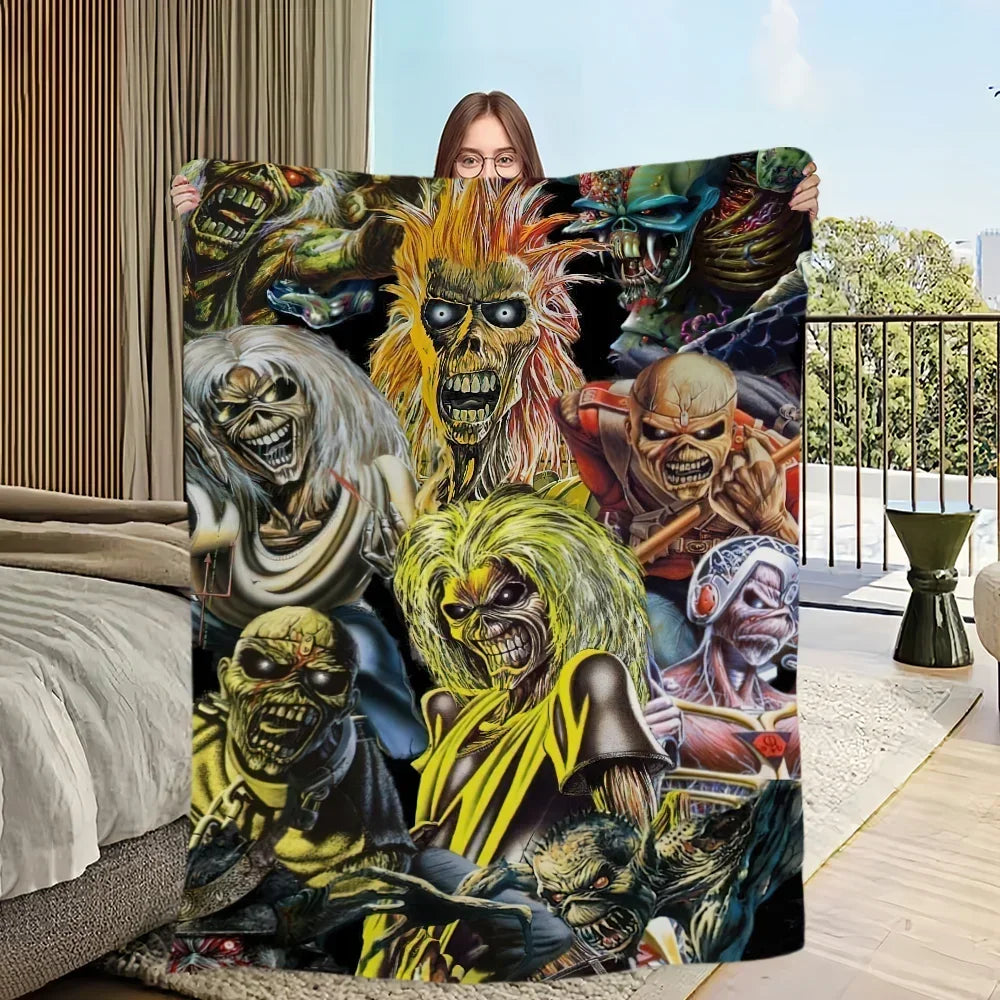 A blanket featuring a dark, intense graphic design of multiple skeletal and demonic figures with fiery accents.