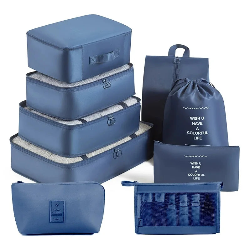 A set of blue travel storage organizers including a box, pouches, and a fabric bag.